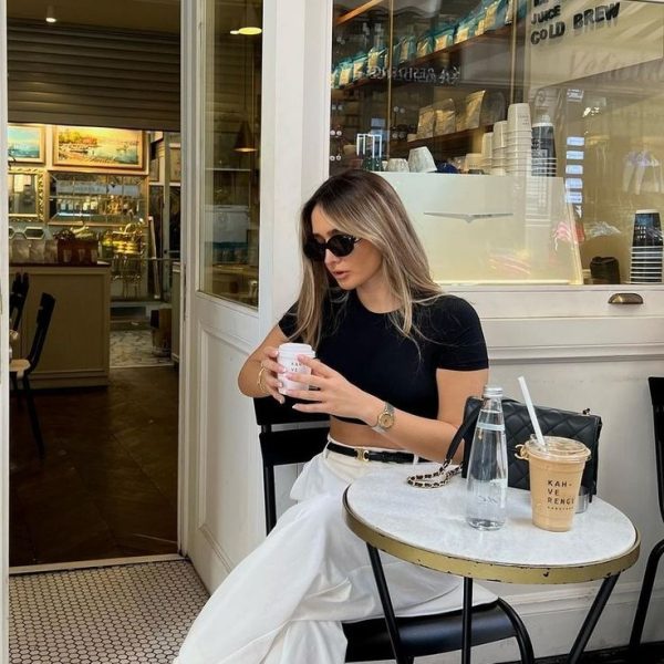Casual Day Out in Oversized T Shirt by UPIKAS CREATION T shirts for everylook - Young woman in embroidered Upikas Creation T shirt enjoying coffee at a cafe